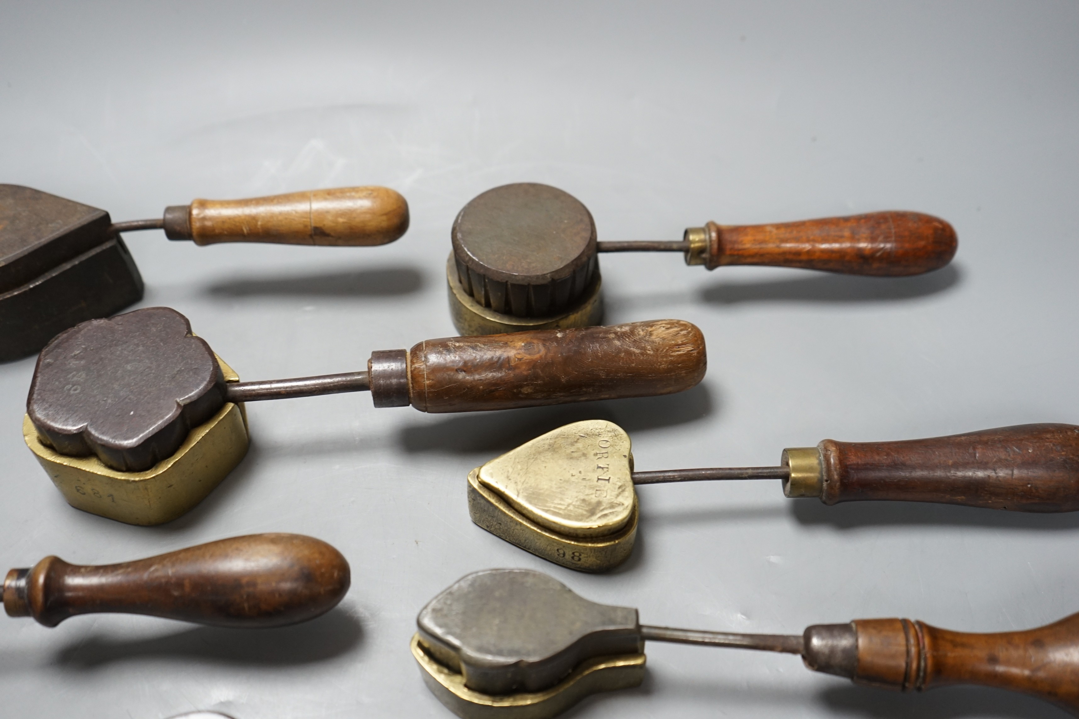 A collection of eight 19th century cast metal moulds for possibly hand embossing silk